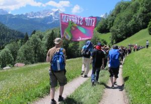 Protesters carry a banner that reads Stop TTIP on their way down an alpine path after trying - and failing -  to reach the G-7 venue in Schloss Elmau hotel (--newstimes.com)