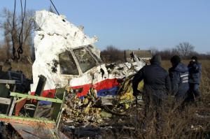Local workers transport a piece of wreckage from flight MH17 at the site of the plane crash near the village of Hrabove (Grabovo) in Donetsk region, eastern Ukraine on Nov. 20, 2014. (--Reuters/Antonio Bronic)
